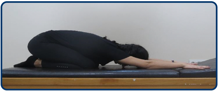 Dizlerinizin üzerinde oturma pozisyonunda öne doğru eğilin. Kollarınızla ileri doğru uzanmaya çalışırken göğsünüzü olabildiğince zemine yaklaştırmaya çalışın. Bu pozisyonda 5 sn tutun ve gevşeyin.